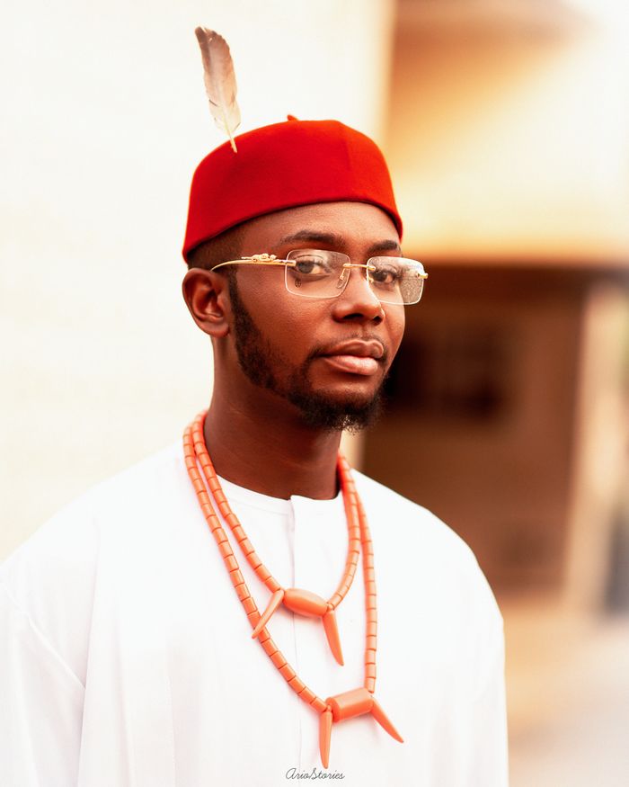 Services Man wearing traditional Igbo attire with red cap and beads, symbolizing cultural pride.