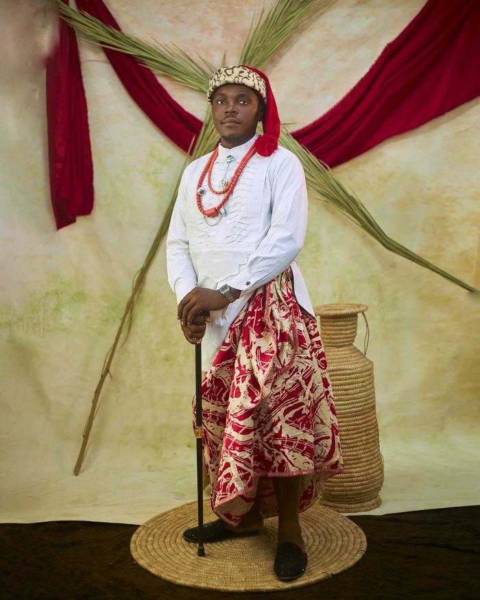 Services Portrait of a man in traditional African attire with cultural decor.